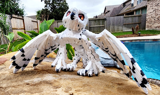 3D printed articulated Snow Gryphon fidget desk toy.