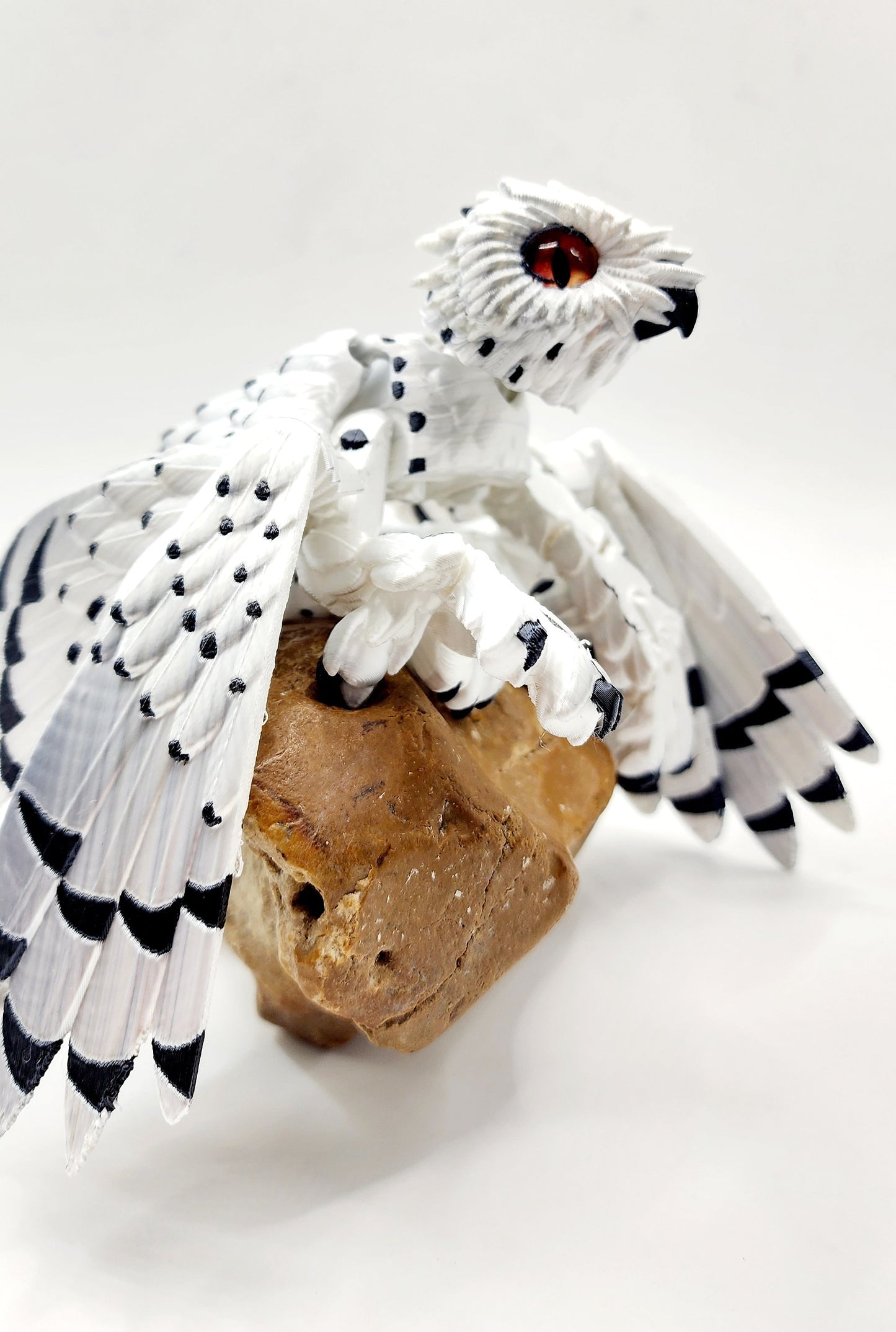 3D printed articulated Snow Gryphon fidget desk toy.