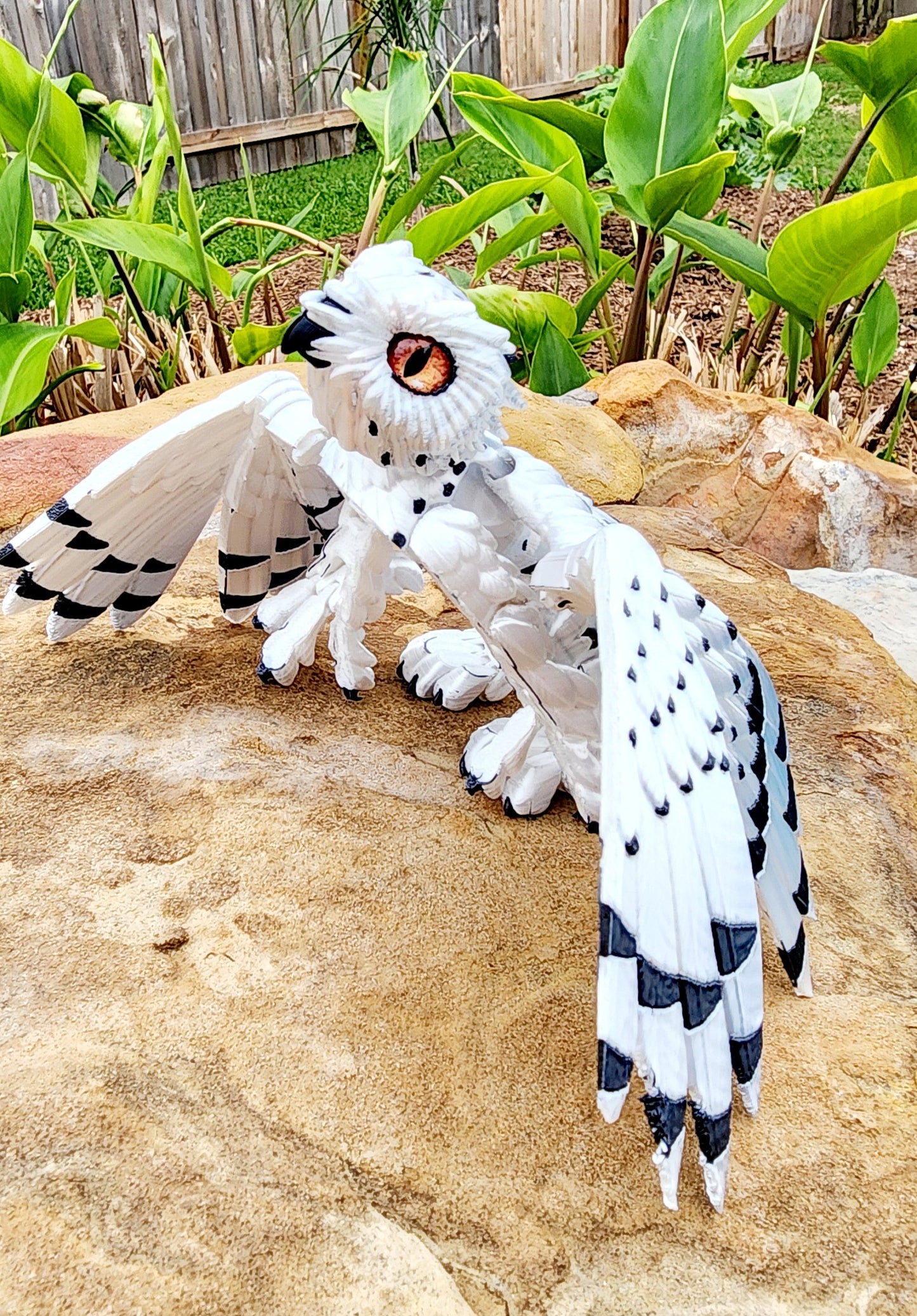 3D printed articulated Snow Gryphon fidget desk toy.