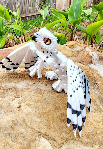 3D printed articulated Snow Gryphon fidget desk toy.