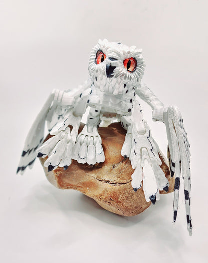 3D printed articulated Snow Gryphon fidget desk toy.