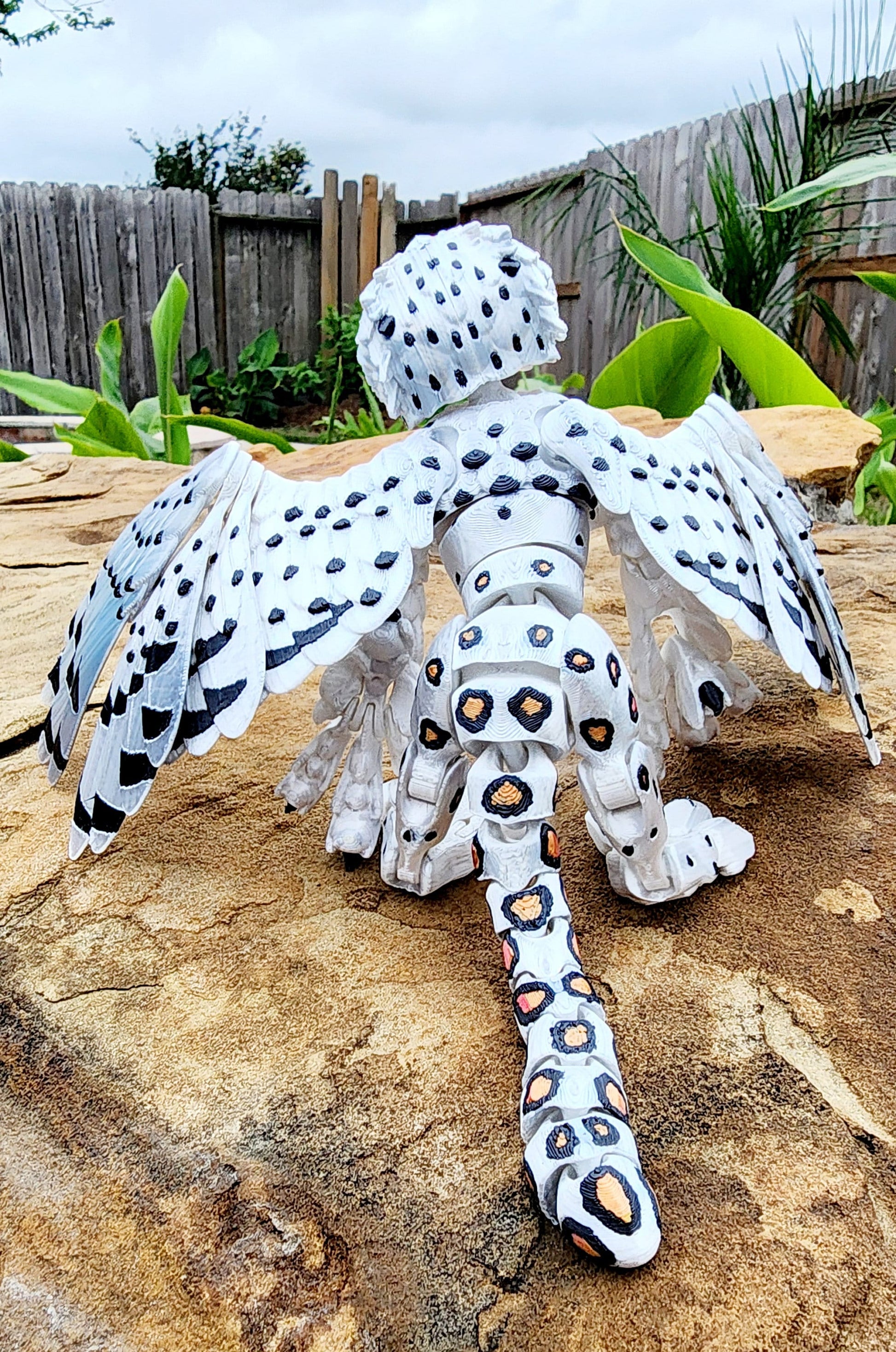 3D printed articulated Snow Gryphon fidget desk toy.